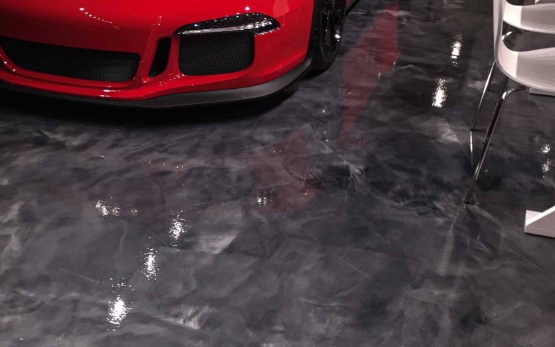 Titanium epoxy flooring for garage with red automobile