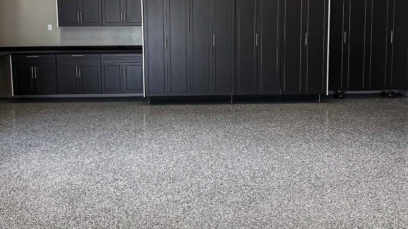 Up close garage flooring with california grey cabinets.