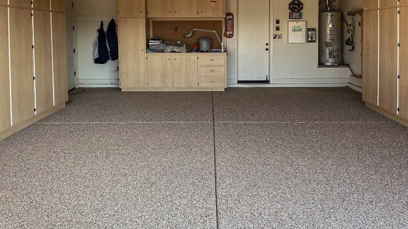 Custom garage storage solution with flake flooring installed.