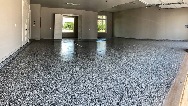 Inside look at a 3 car garage with flake flooring.