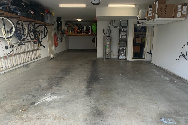 Before picture of flake saddle tan epoxy floor for cyclists garage