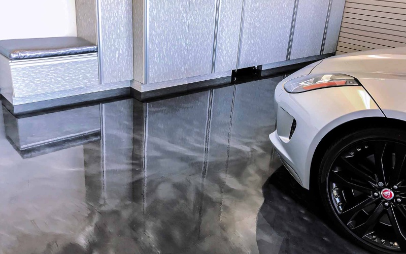 Gunmetal epoxy flooring for garage with one white sports car