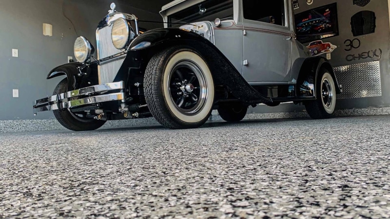 Up close look at a flake floor with a vintage car.